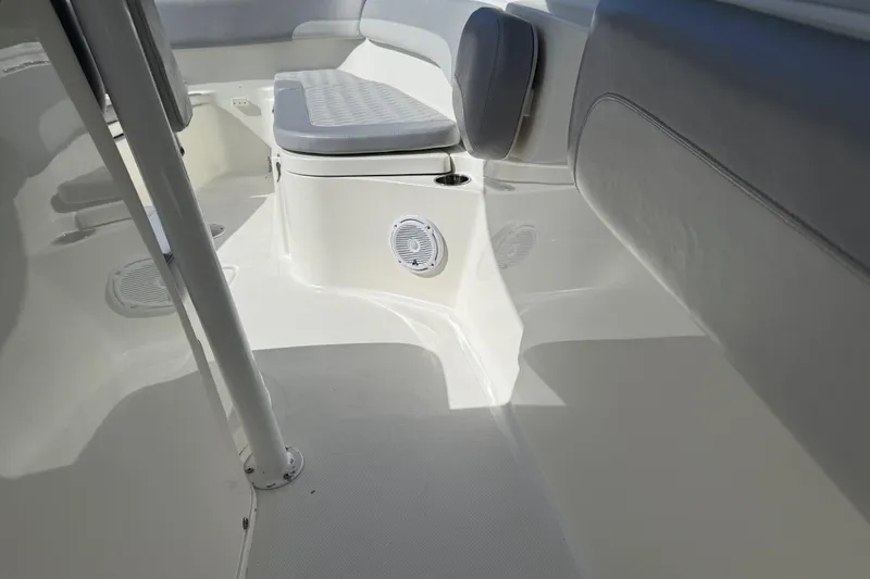 Slide: The Image of 2018 NauticStar 28 XS boat interior with cushioned seating and speaker. - 17