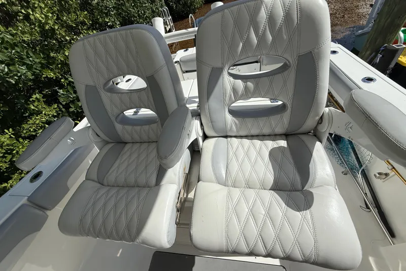 Slide: The Image of 2018 NauticStar 28 XS boat with dual cushioned seats, diamond-stitched upholstery. - 22