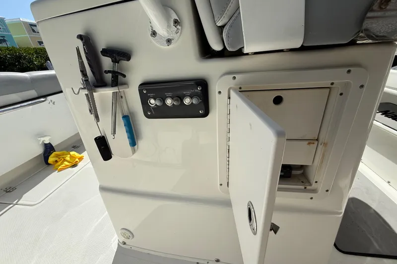 Slide: The Image of 2018 NauticStar 28 XS boat interior with tools and open storage compartment. - 28