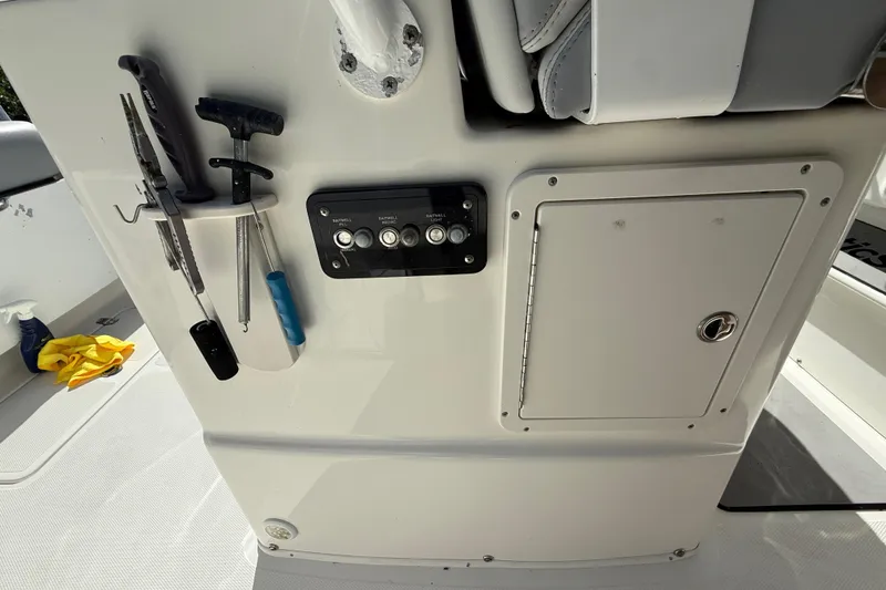 Slide: The Image of 2018 NauticStar 28 XS boat console with tools and storage compartment. - 29