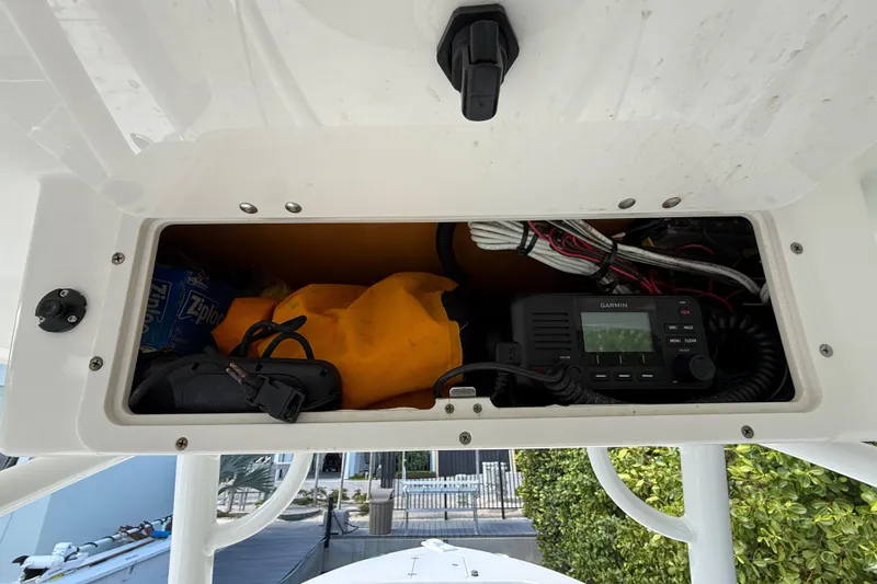 Slide: The Image of Storage compartment of 2018 NauticStar 28 XS boat with Garmin device and accessories. - 30