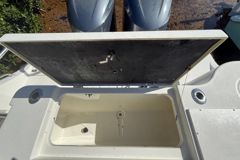 Slide: The Image of Open storage compartment on 2018 NauticStar 28 XS boat, showing interior details. - 37