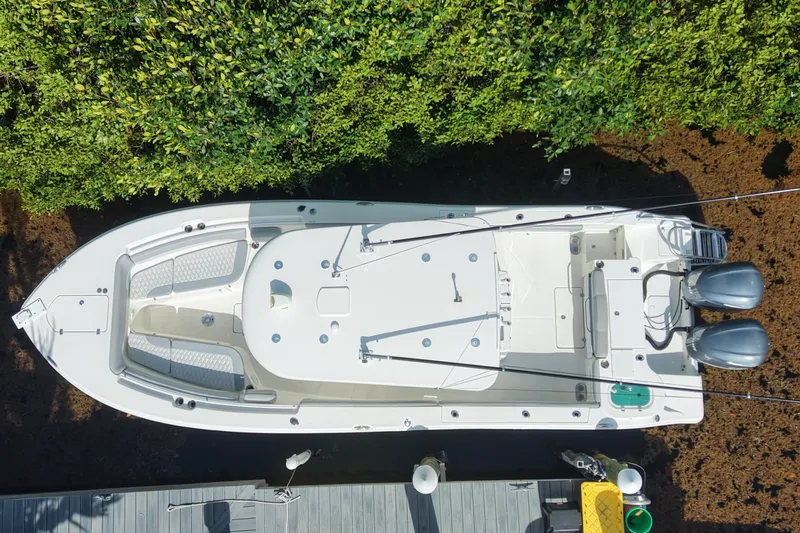Slide: The Image of Aerial view of 2018 NauticStar 28 XS boat docked near lush greenery. - 5