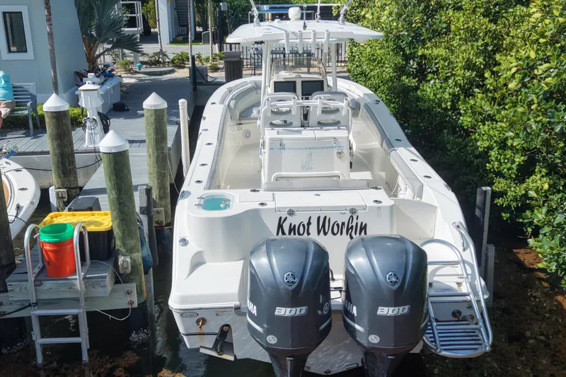 Slide: The Image of 2018 NauticStar 28 XS boat docked, featuring twin Yamaha engines. - 8