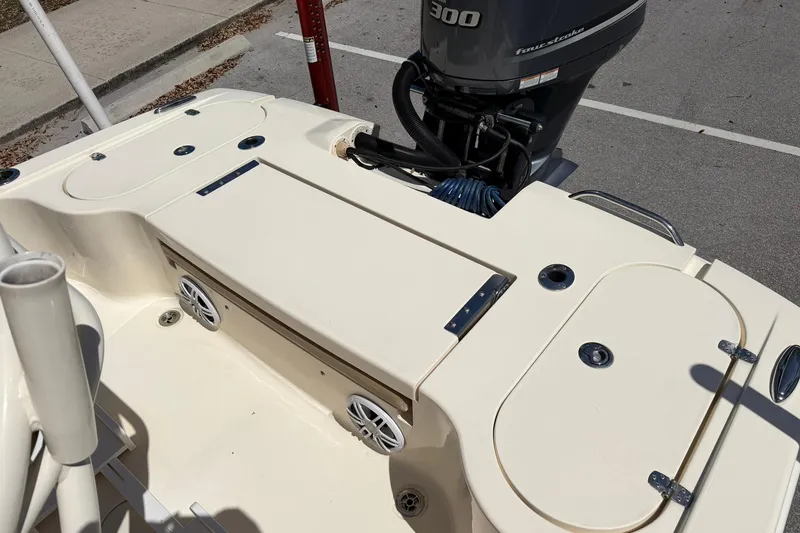 Slide: The Image of 2018 Scout 231 XS boat deck with storage compartments and outboard motor. - 10