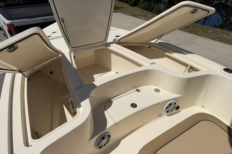 Slide: The Image of 2018 Scout 231 XS boat with open storage compartments and speakers on deck. - 19