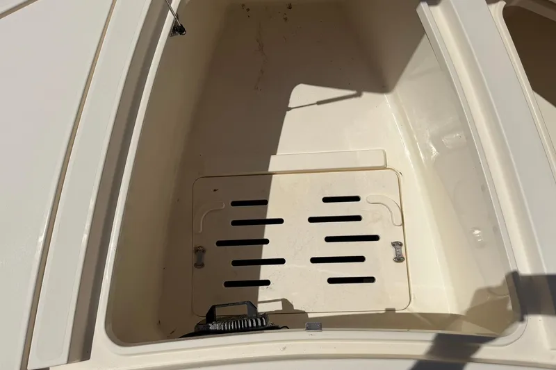 Slide: The Image of 2018 Scout 231 XS boat storage compartment with open hatch, showing interior details. - 20