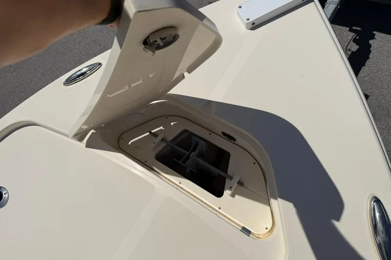 Slide: The Image of Open hatch on 2018 Scout 231 XS boat deck, showing storage compartment. - 21