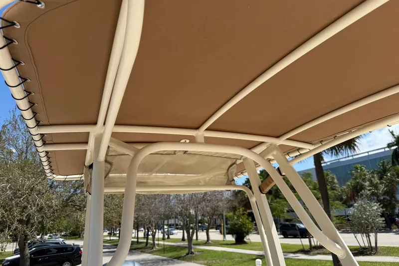 Slide: The Image of 2018 Scout 231 XS boat canopy with beige cover and sturdy frame. - 26