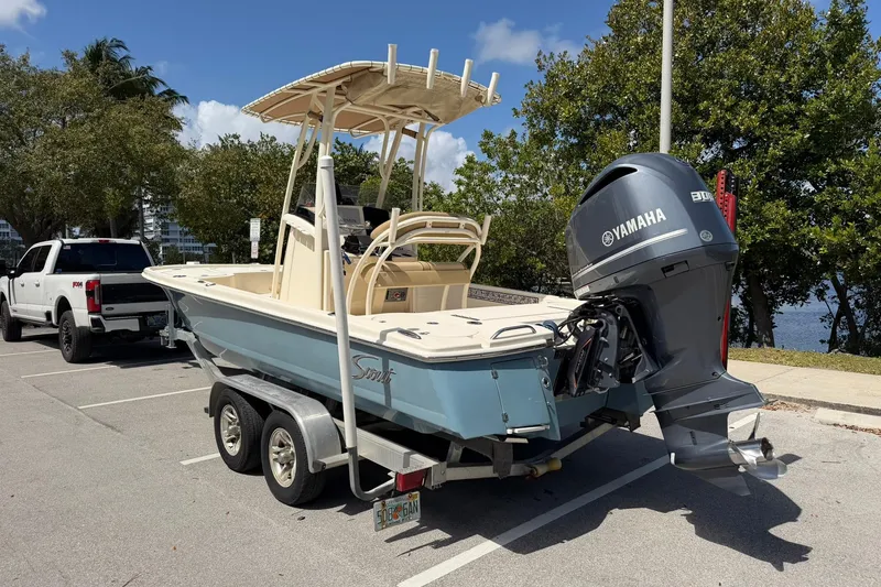 Slide: The Image of 2018 Scout 231 XS boat on trailer with Yamaha engine in parking lot. - 3