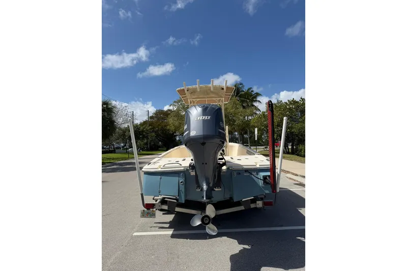 Slide: The Image of 2018 Scout 231 XS boat with powerful outboard motor, parked under clear blue sky. - 4