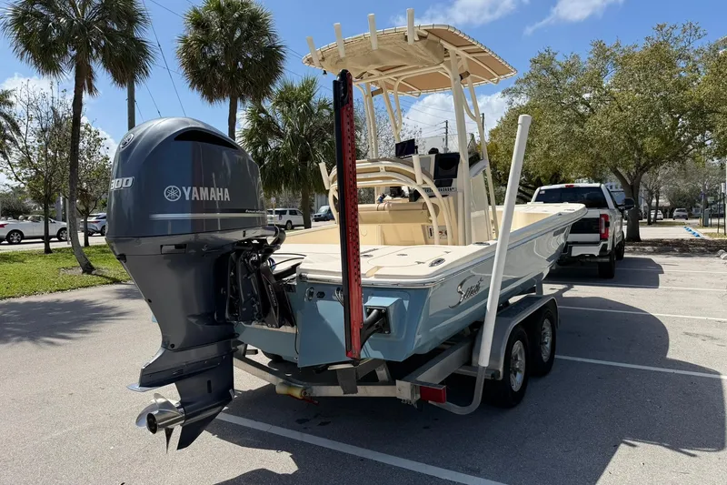 Slide: The Image of 2018 Scout 231 XS boat with Yamaha engine on trailer in sunny parking lot. - 5