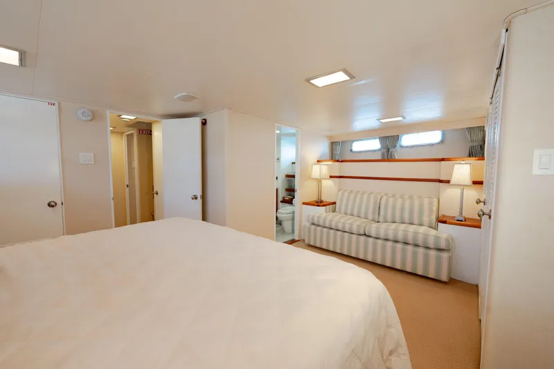 Slide: The Image of Luxurious 1969 Custom Hargrave yacht interior with cozy bedroom and elegant seating area. - 10