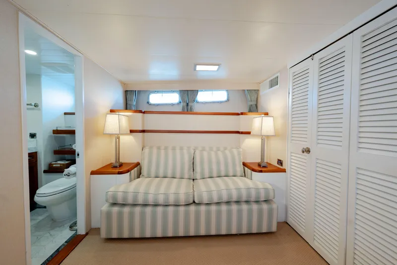 Slide: The Image of Cozy 1969 Custom Hargrave yacht interior with striped sofa, lamps, and bathroom. - 11