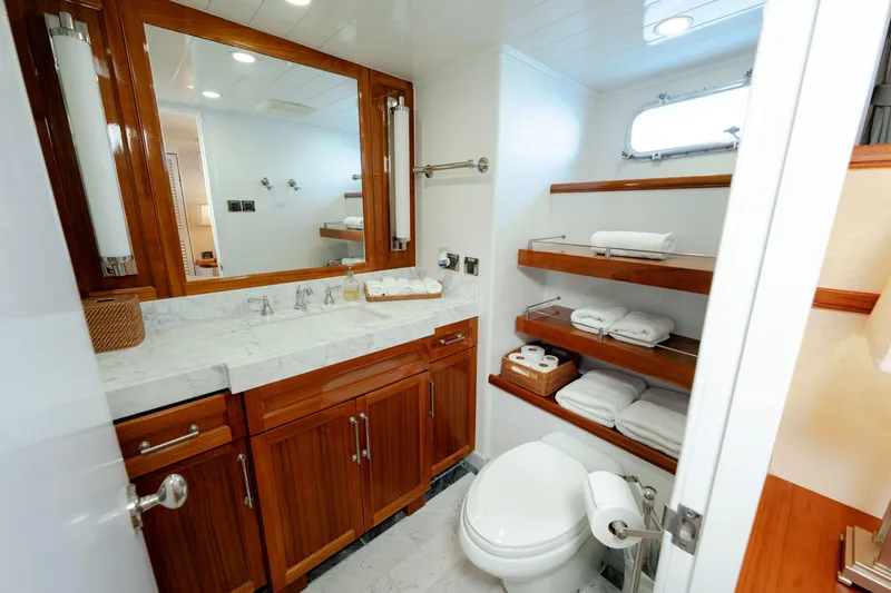 Slide: The Image of Luxurious 1969 Custom Hargrave yacht bathroom with wooden cabinets and marble countertop. - 12