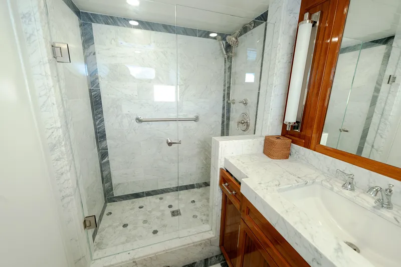 Slide: The Image of Luxurious marble bathroom with glass shower in a 1969 Custom Hargrave model. - 13
