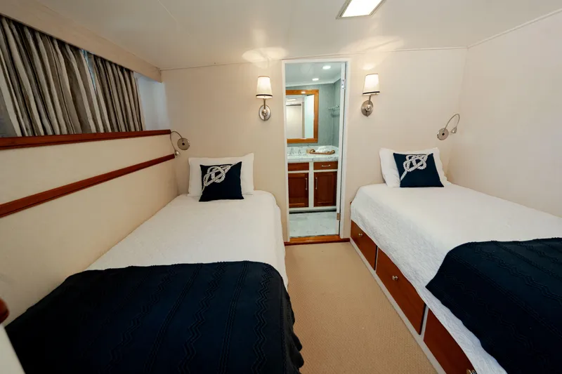 Slide: The Image of Twin cabin interior on 1969 Custom Hargrave yacht, featuring elegant decor and ensuite bathroom. - 15