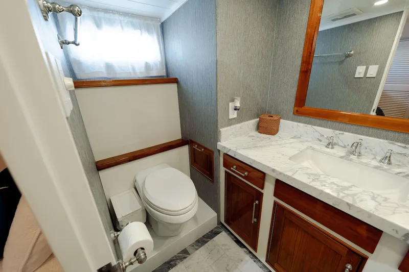 Slide: The Image of Luxurious 1969 Custom Hargrave yacht bathroom with marble countertop and wooden accents. - 16