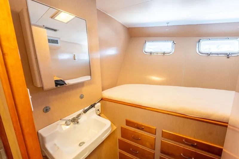 Slide: The Image of Cozy cabin interior of 1969 Custom Hargrave yacht with sink, mirror, and bed. - 23