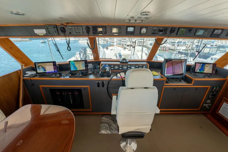 Slide: The Image of Interior of a 1969 Custom Hargrave yacht cockpit with navigation equipment and marina view. - 26