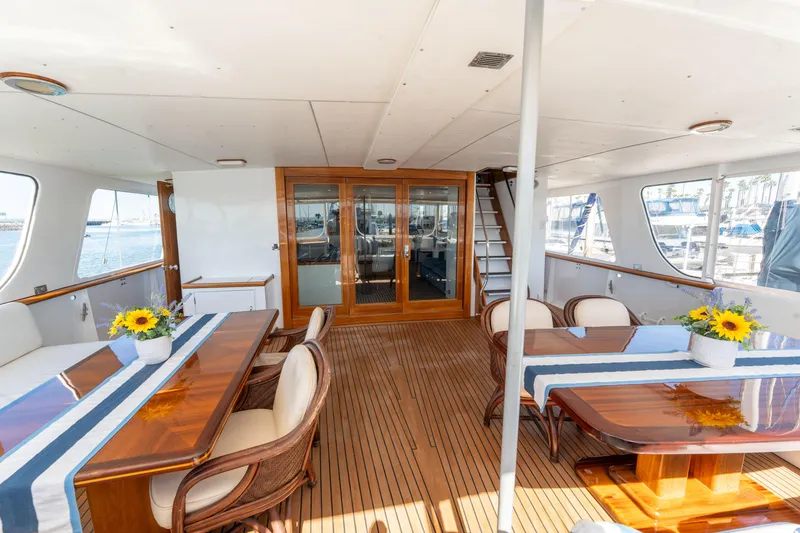 Slide: The Image of Luxurious 1969 Custom Hargrave yacht interior with elegant dining area and sunflower decor. - 32