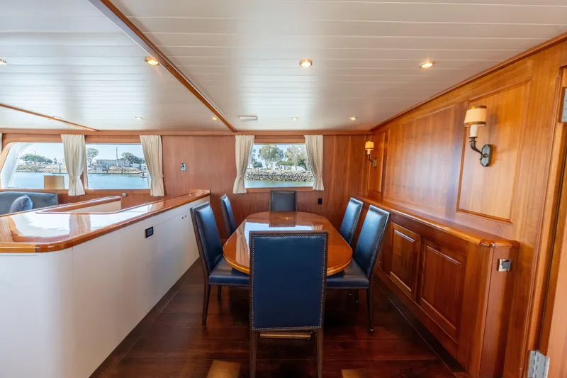 Slide: The Image of Luxurious 1969 Custom Hargrave yacht interior with elegant wood paneling and dining area. - 6
