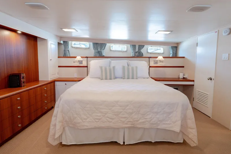 Slide: The Image of Luxurious 1969 Custom Hargrave yacht bedroom with elegant wood cabinetry and plush bedding. - 8