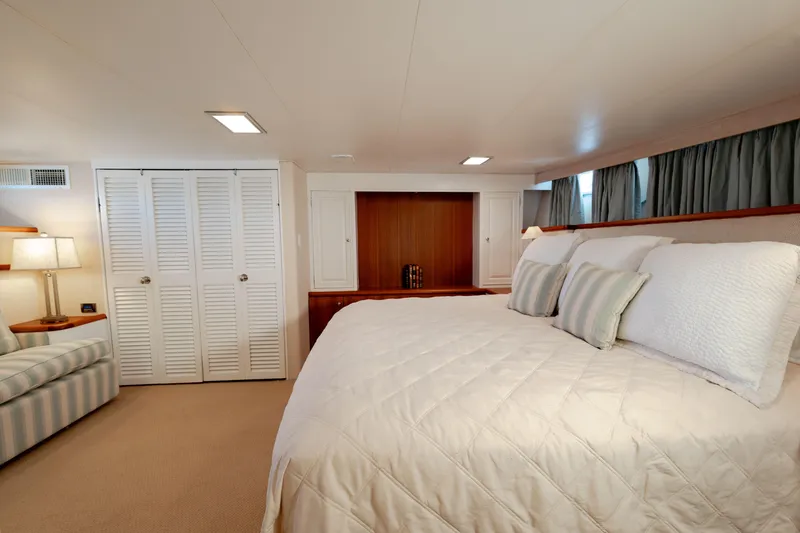 Slide: The Image of Luxurious bedroom interior on a 1969 Custom Hargrave yacht, featuring elegant bedding and cozy lighting. - 9
