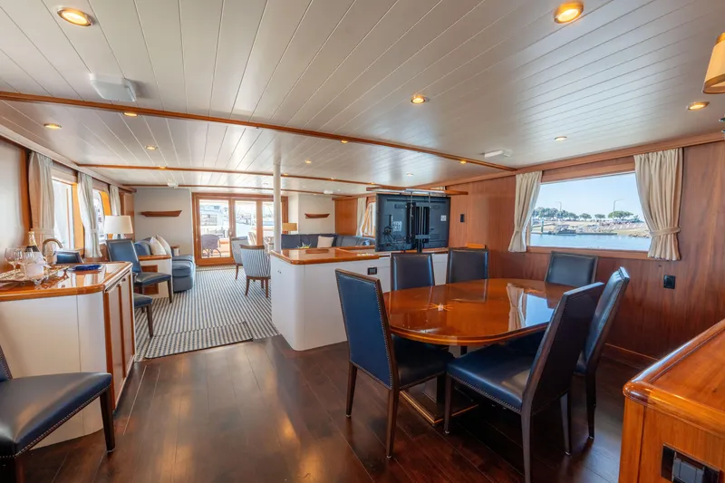 Slide: The Image of Luxurious 1969 Custom Hargrave yacht interior with elegant dining area and scenic window views. - 1