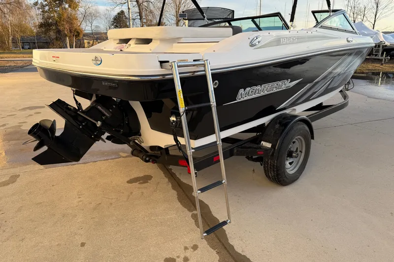 Slide: The Image of 2017 Monterey 196FS boat with trailer, black and white design, rear view with ladder. - 11
