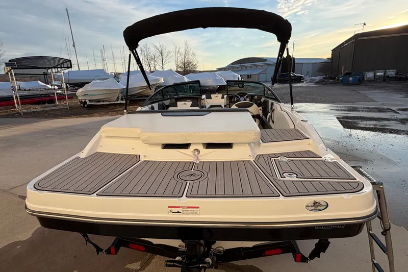 Slide: The Image of 2017 Monterey 196FS boat with sleek design, docked outdoors at sunset. - 12
