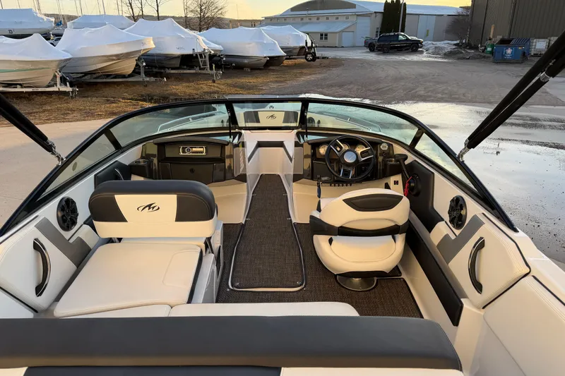 Slide: The Image of Interior of a 2017 Monterey 196FS boat, featuring sleek seating and modern dashboard. - 13