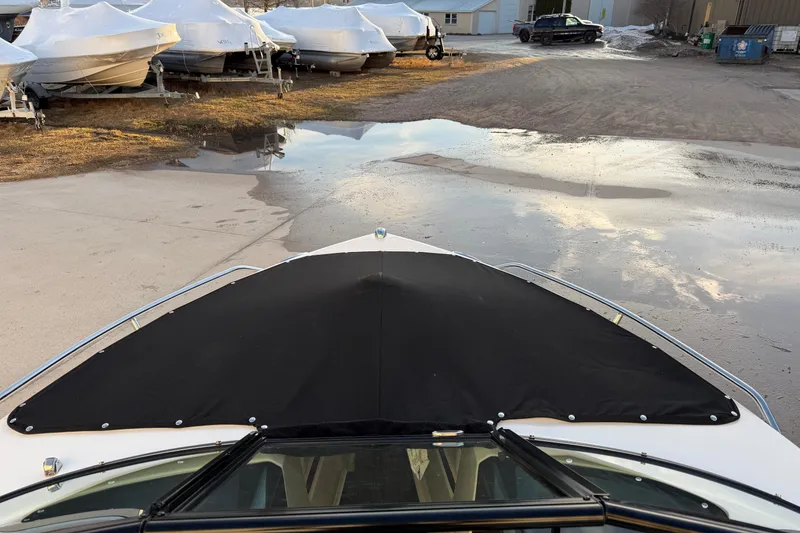 Slide: The Image of 2017 Monterey 196FS boat with black cover, parked near other covered boats. - 34