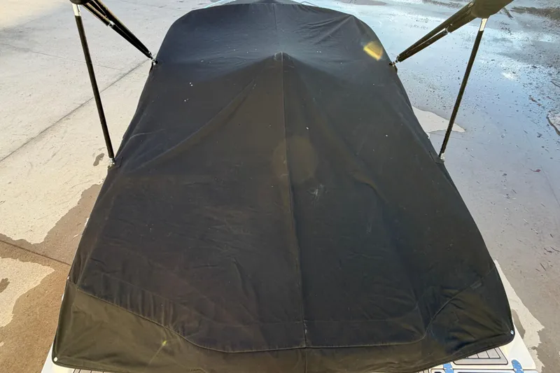 Slide: The Image of Covered 2017 Monterey 196FS boat with black tarp on a wet surface. - 35