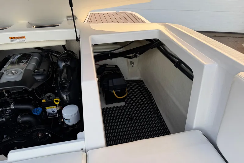 Slide: The Image of Engine compartment of a 2017 Monterey 196FS boat, showcasing the engine and storage area. - 36