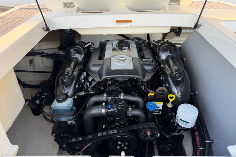 Slide: The Image of Engine compartment of a 2017 Monterey 196FS boat, showcasing detailed components and layout. - 37