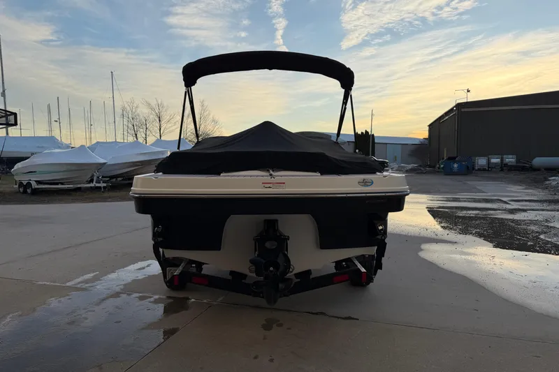 Slide: The Image of 2017 Monterey 196FS boat with cover, parked outdoors at sunset. - 4