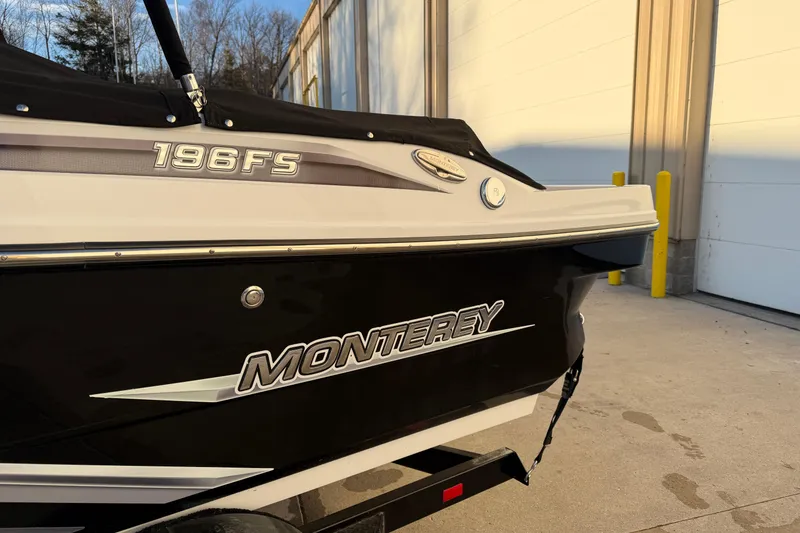 Slide: The Image of 2017 Monterey 196FS boat, black and white exterior, parked near a building. - 8