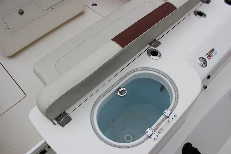 Slide: The Image of 2022 Cobia 280 Center Console boat interior with seating and livewell. - 15