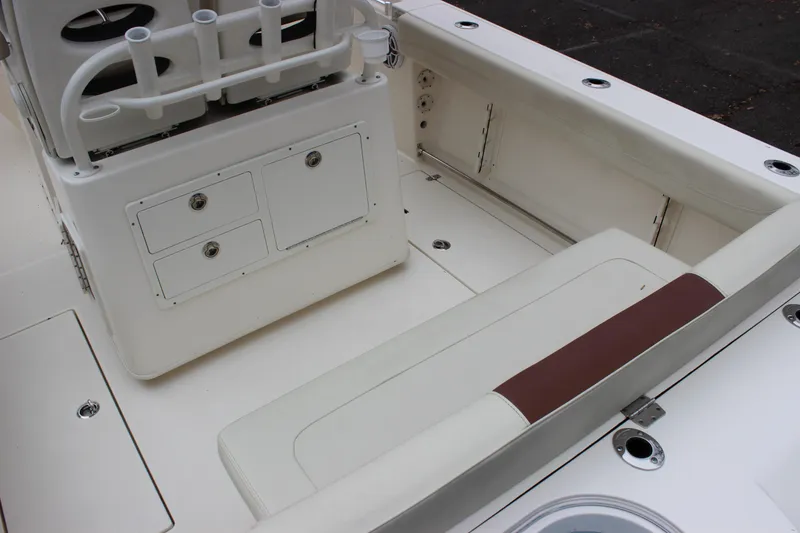 Slide: The Image of 2022 Cobia 280 Center Console boat interior with seating and storage compartments. - 16