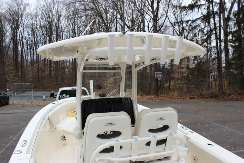 Slide: The Image of 2022 Cobia 280 Center Console boat in wooded area, rear view. - 18