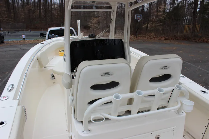 Slide: The Image of 2022 Cobia 280 Center Console boat interior with dual seats and rod holders. - 19