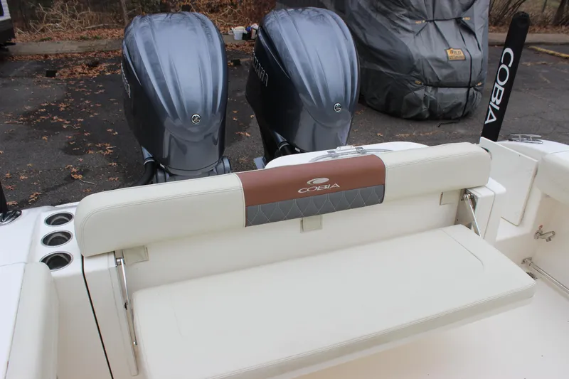 Slide: The Image of 2022 Cobia 280 Center Console boat with dual engines and cushioned seating. - 20