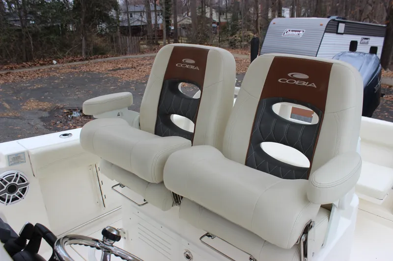 Slide: The Image of 2022 Cobia 280 Center Console boat seats, featuring dual cushioned chairs with armrests. - 21