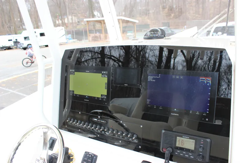 Slide: The Image of Cobia 280 Center Console 2022 dashboard with Garmin navigation displays and controls. - 31