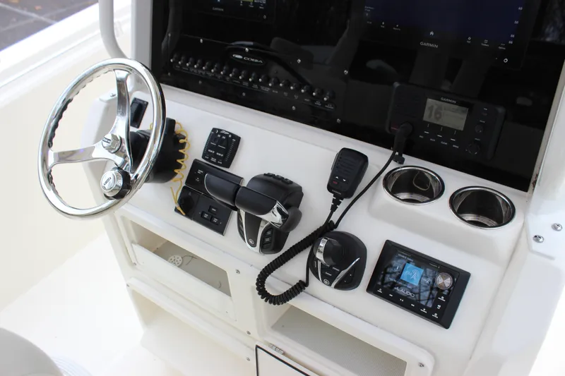 Slide: The Image of 2022 Cobia 280 Center Console dashboard with steering wheel and navigation controls. - 32