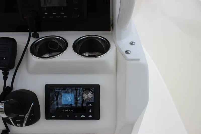 Slide: The Image of Center console of 2022 Cobia 280 with JL Audio system and cup holders. - 33