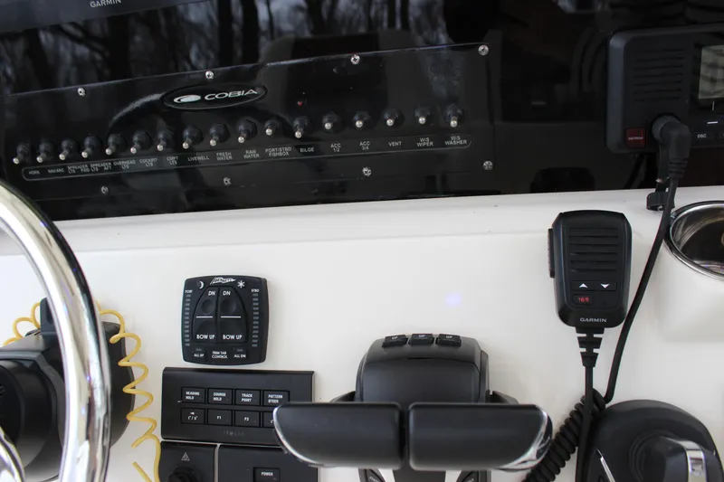 Slide: The Image of 2022 Cobia 280 Center Console dashboard with controls and Garmin radio equipment. - 34