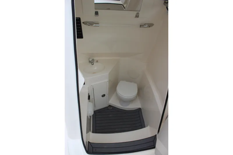 Slide: The Image of 2022 Cobia 280 Center Console boat interior bathroom with toilet and sink. - 39