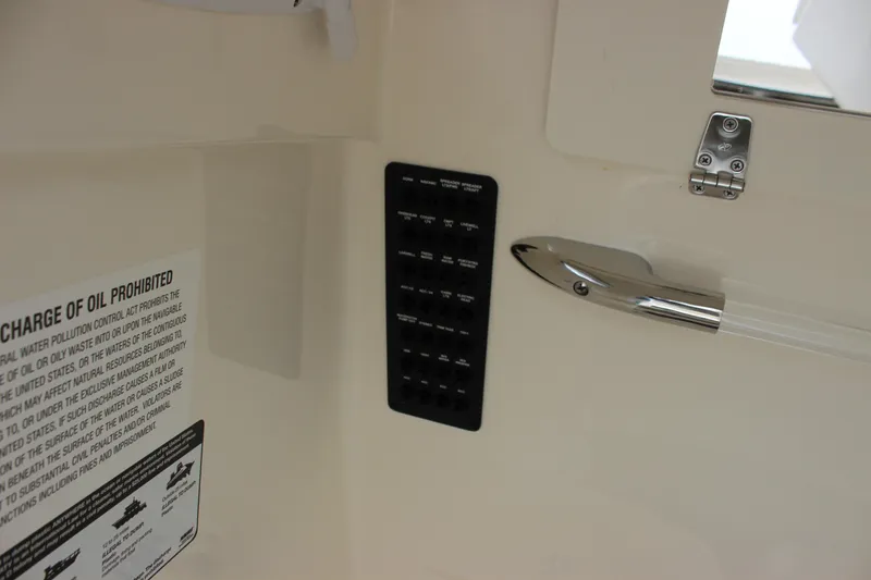 Slide: The Image of 2022 Cobia 280 Center Console interior with control panel and safety notice. - 41
